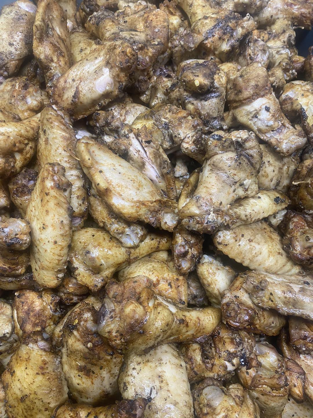 large amount of seasoned chicken wings from The Piggy BBQ